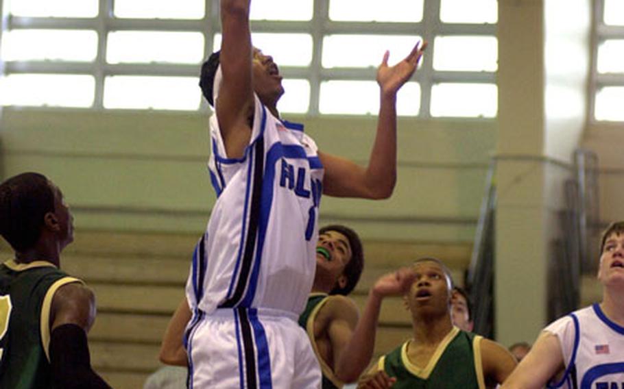 Seoul American High School's Jay Higgins puts up a layup while defenders from Robert D. Edgren look on during the fourth quarter Tuesday at the Camp Foster Field House. Higgins and the Falcons won 74-55 during pool play in the Far East Boys Class AA Tournament.