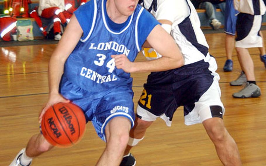 London Central’s Danny Melville drives past Sigonella’s Chris Cerame in a Division III in an opening-round tournament game on Thursday in Mannheim, Germany. London Central defeated Sigonella 57-51.