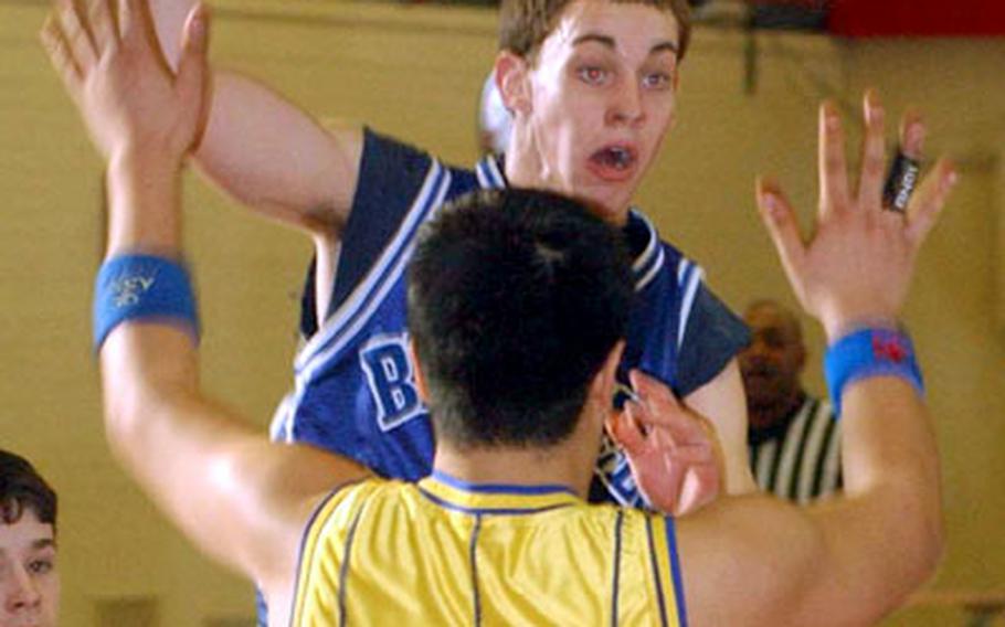 Logan Quinn of Brussels looks to pass to a teammate over Iceland&#39;s Jay Sison. Quinn was voted Division IV tournament MVP.