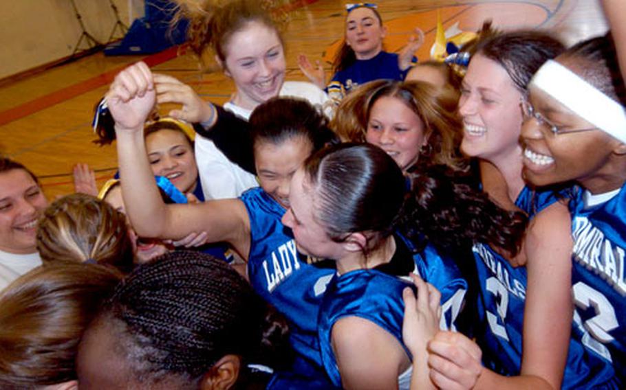 The Rota Lady Admirals celebrate their DODDS Division III title after defeating Ansbach.