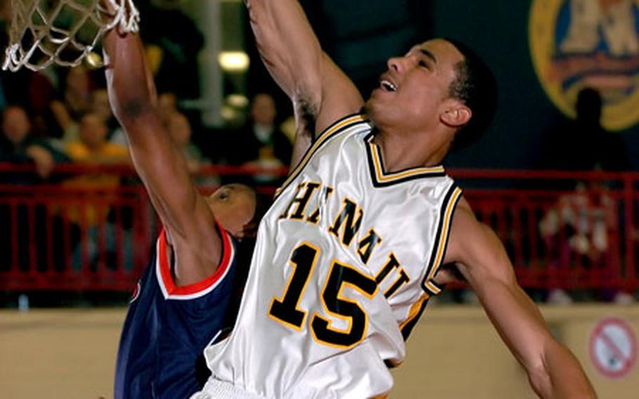 Hanau's Malcolm Lane, right, drives to the hoop over Aviano's Carl Cephas during the boys Division II championship game in Mannheim, Germany, on Saturday. Lane scored 11 points and was named Tournament MVP as Hanau defeated Aviano 50-37 to win the title.
