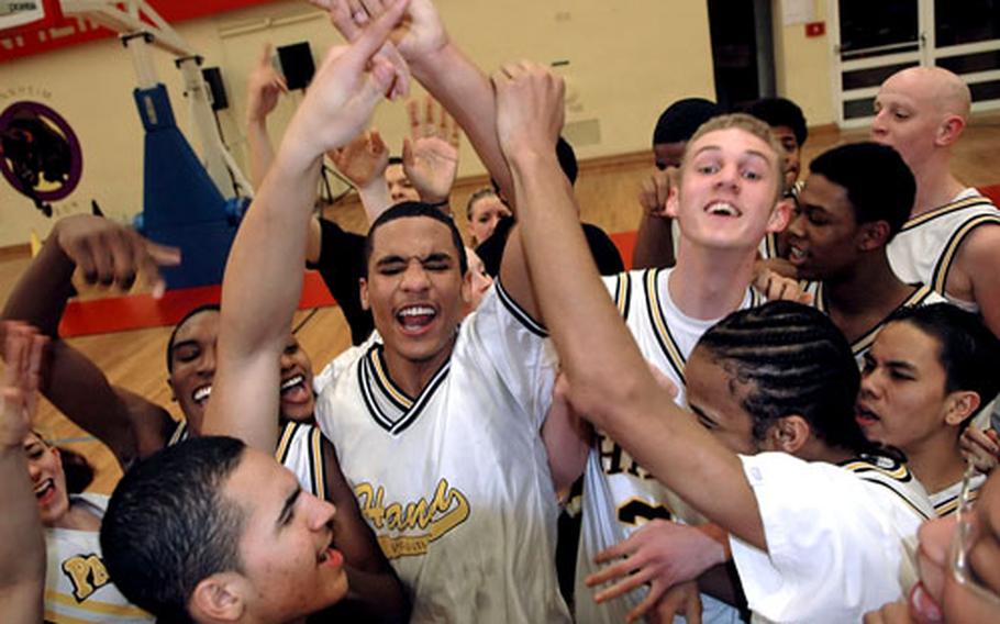 Hanau players celebrate their 50-37 victory over Aviano in the boys Division II championship game in Mannheim, Germany, on Saturday.