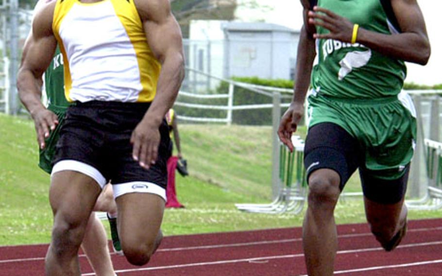 Kadena’s David McCowan, left, and Kubasaki’s Tony Price race in the 100-meter dash Friday at Camp Foster, Okinawa. McCowan crossed the finish line in 11.75 seconds, .07 seconds faster than Price.