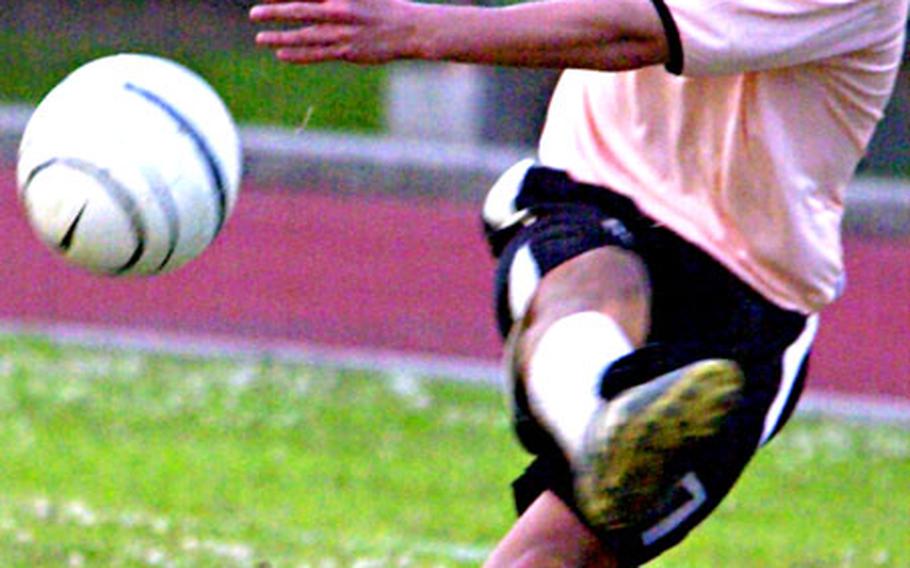 Mitsuo Sato of Okinawa Coronas launches a shot at the Kadena Falcons’ net during Sunday’s championship in the Kadena Kup soccer tournament at Kadena Air Base, Okinawa. Coronas edged Kadena 1-0.