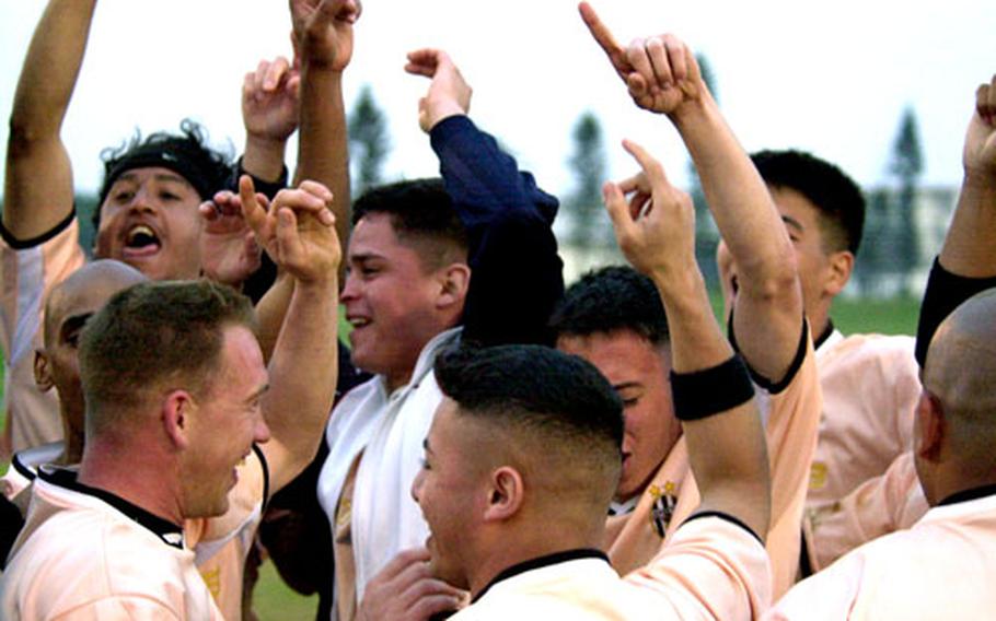 Members of the Okinawa Coronas celebrate their victory over the Kadena Falcons in the Kadena Kup championship game.