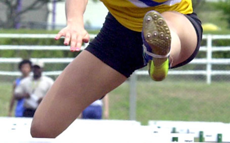 Christian Academy In Japan senior Jennifer Reed runs to victory in the 100-meter hurdles Saturday at Camp Foster, Okinawa.