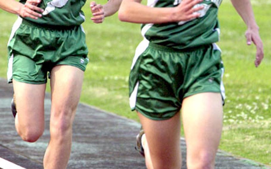 Lisa, right, and Beth Nielsen push for the finish line during the 1,600-meter race at a recent meet at Camp Foster. Lisa took first in 6 minutes, 12 seconds, and Beth was second, two seconds behind.