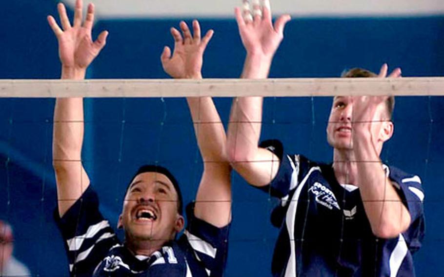 Ramstein&#39;s Joey Perez, left, and Ronald Iske try to block a shot against Heidelberg during the championship game of the Army/AirForce Final Four volleyball tournament in Wiesbaden, Germany, on Sunday.