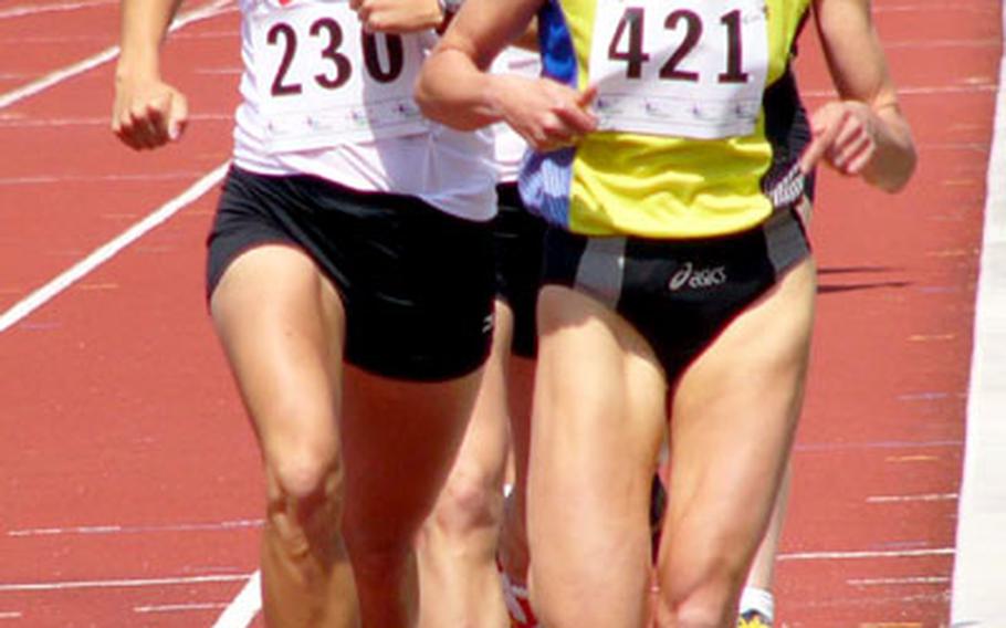 Caitlin Reese (230) of Patrick Air Force Base, Fla., followed closely by her sister Sarah of Kirtland Air Force Base, N.M., hangs onto the shoulder of Belgium’s Anya Smolders in the 1,500 meters Wednesday in the international air forces track and field championships at Herentals, Belgium. Caitlin finished second to Smolders in 4:34.57 and Sarah placed third in 4:49.84. Smolders won in 4:31.91, but the U.S. women claimed their fifth straight title, 38-20 over Germany.