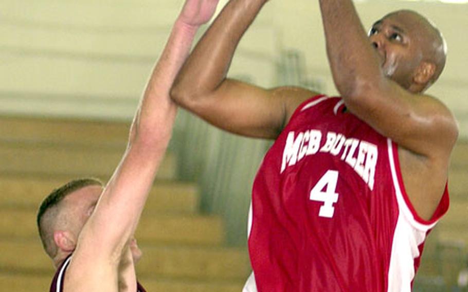 Yonnes Sanders of Marine Corps Base Camp Butler goes up for a shot as Andrew Wohlgemuth of 3rd Force Service Support Group defends during Monday&#39;s round-robin play in the 2005 Marine Forces Pacific Regional Basketball Tournament at Camp Foster, Okinawa.