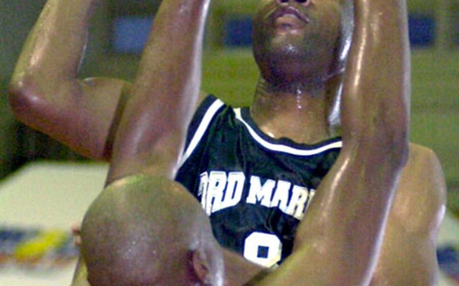 Kyle Scott of 3rd Marine Division/Expeditionary Force shoots over Robert Avery of Marine Corps Base Camp Butler during Friday's championship game in the 2005 Marine Forces Pacific Regional Basketball Tournament at Camp Foster, Okinawa. Scott scored a game-high 27 points in a losing cause as Base beat Division 80-71 for its second straight title.