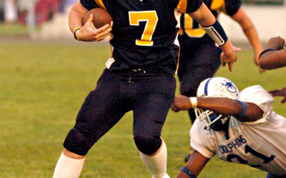 Yokota Warriors quarterback L.C. Ooten evades the Atsugi White Dolphins during Saturday’s USFJ-AFL game at Atsugi Naval Air Facility, Japan. Yokota won 24-13.