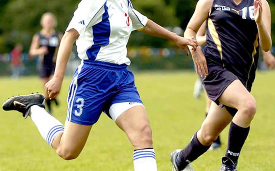 Ramstein’s Mari Shakir fires a shot just wide of the goal post as Heidelberg’s Ana Anger gives chase during the the DODDS European Division I high school girls soccer championship game last month in Ramstein, Germany. Shakir and Anger were both named to the 2005 All-Europe team. (spt# 54p cs)