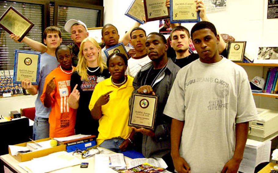 Ansbach senior student-athletes show off some of the hardware they have helped the school win during the past three years. They are, from left, rear: Adam Golden, Mike Ewing, Russell Bailey, Taurean Moore and Brandon Bachtel; and from left, front row Brittney Britton, Alison Hazen, Keke Johnson, James Esters and Dameon Outley.