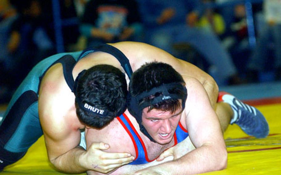Cole Maxey of Ramstein, bottom, rallied to win the 215-pound title with a pin in the DODDS-Europe wrestling championships in February. Maxey, in his first season since transferring from Okinawa, was 21-0.