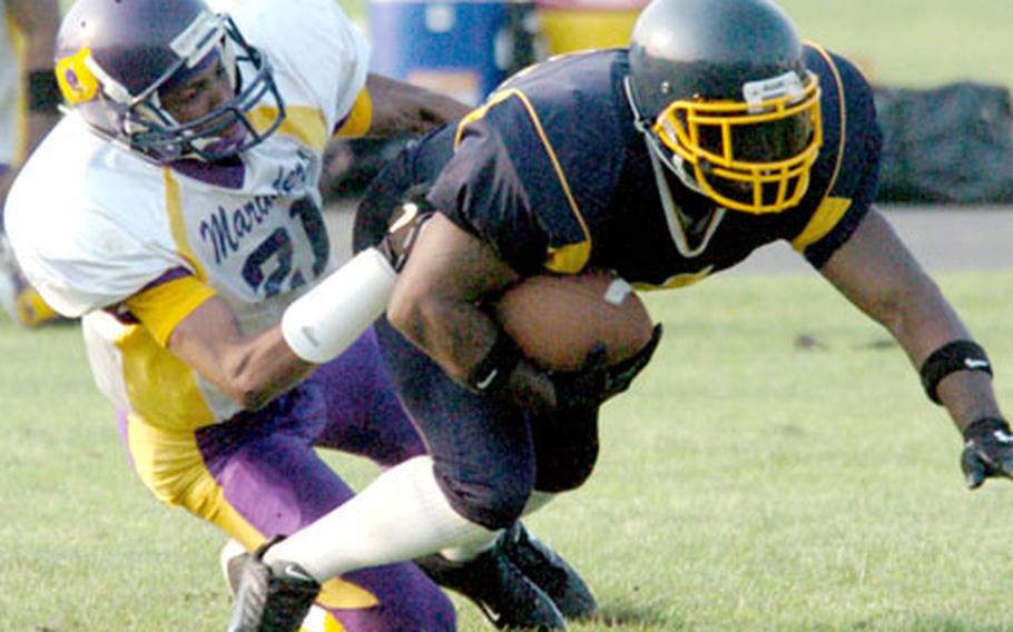 Misawa defender Mike Jackson tackles Yokota running back Bobby Boone.