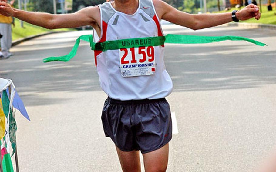 Spc. Edmond Chapa wins the men’s division of the Army 10-Miler European qualifier Saturday at the Grafenwöhr training area in Germany.