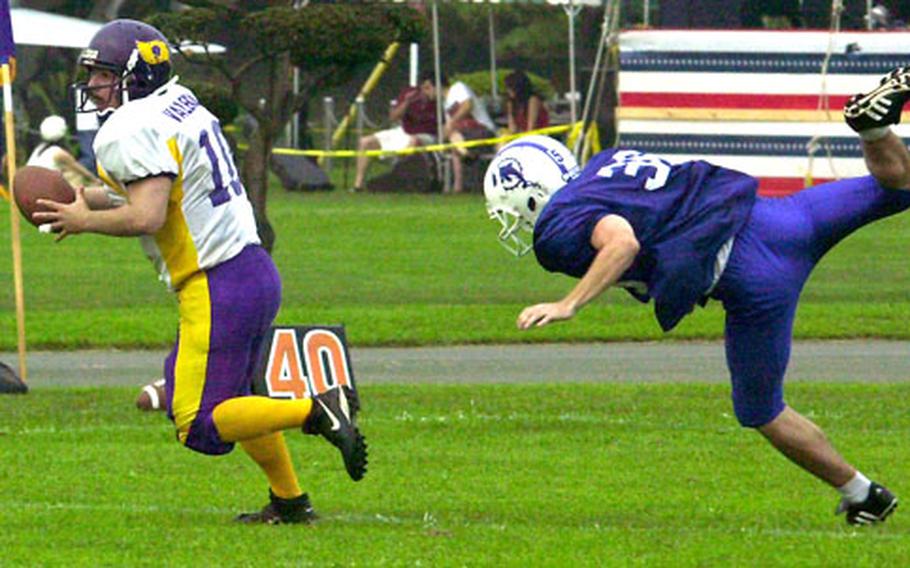 Misawa Marauders quarterback David Valencia evades Jo Gramling of the Atsugi White Dolphins during Saturday’s USFJ-AFL game.