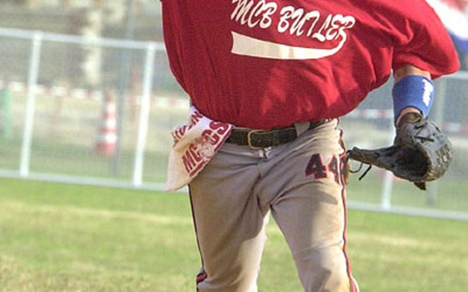 Shortstop Matt Lange of Marine Corps Base Camp Butler guns a throw to first base against 1st Marine Aircraft Wing during Wednesday's first championship game. Base beat Wing twice 22-13 and 18-10 to capture the title.