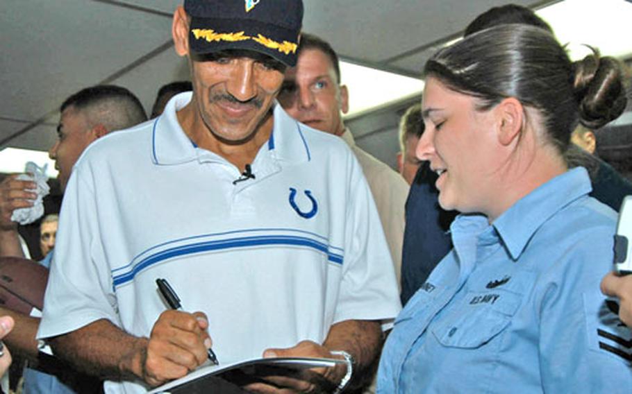 Colts head coach Tony Dungy signs an autograph for Petty Officer 2nd Class Shannanan Arney on the USS Blue Ridge on Friday.