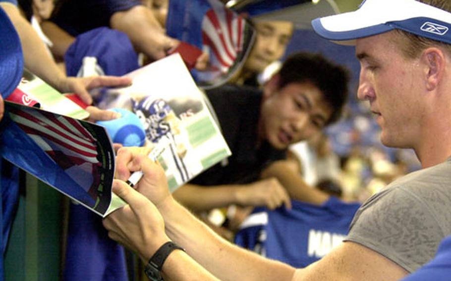 Indianapolis Colts quarterback and Peyton Manning signs autographs before Saturday’s game at Tokyo Dome.