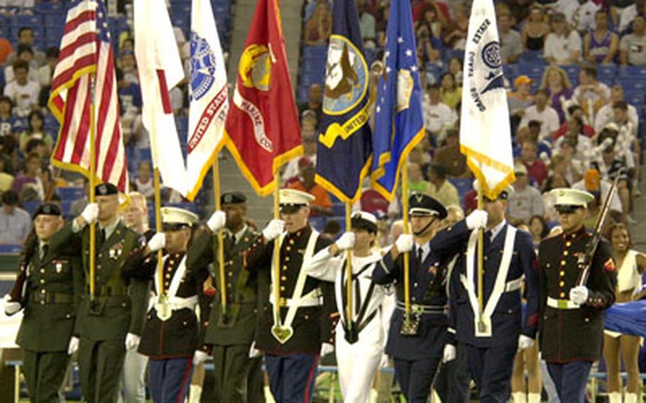 The joint U.S. Forces Japan color guard posts the colors before Saturday’s game. Color guard members were Marine Lance Cpl. Johnny Fouseca and Staff Sgt. Christopher Rosas of Camp Fuji, Air Force Staff Sgt. Andy Infante of Yokota Air Base, Navy Petty Officer 3rd Class Traci Silva of Yokosuka Naval Base, Marine Sgt. Phong Nguyen of USFJ at Yokota, Army Sgt. Michael Blume, Christopher Cox and Josh Rodgers of Camp Zama and Coast Guard Petty Officer 1st Class Stephen Gass of Yokota.