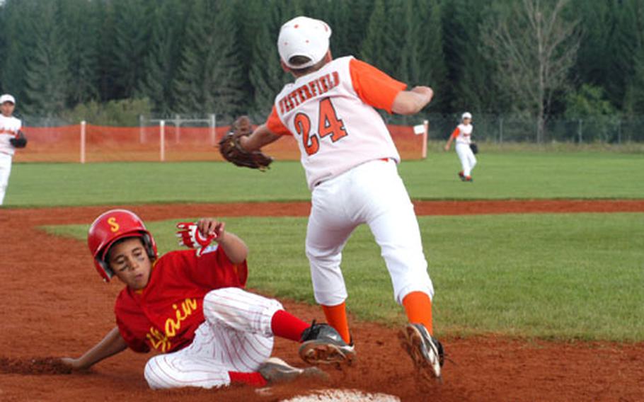 Christian Roman of Rota, Spain, slides safely into third base as John Westerfield of Schinnen, Netherlands, reaches for the throw. Spain defeated the Netherlands 5-0 on Sunday in the Little League TransAtlantic Regional tournament qualifying round in Vilseck, Germany.