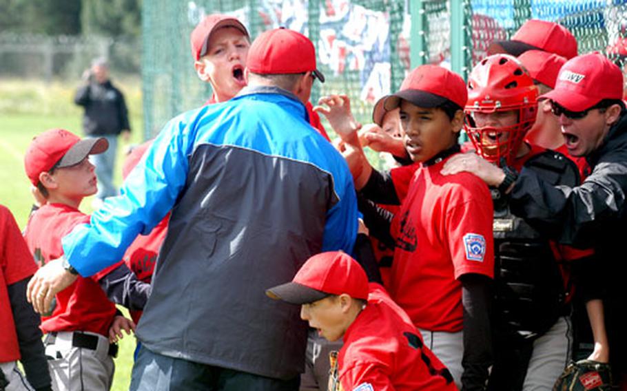 Players and coaches from East Anglia, England, get fired up before taking the field Sunday for their game against the Arabian-American team.