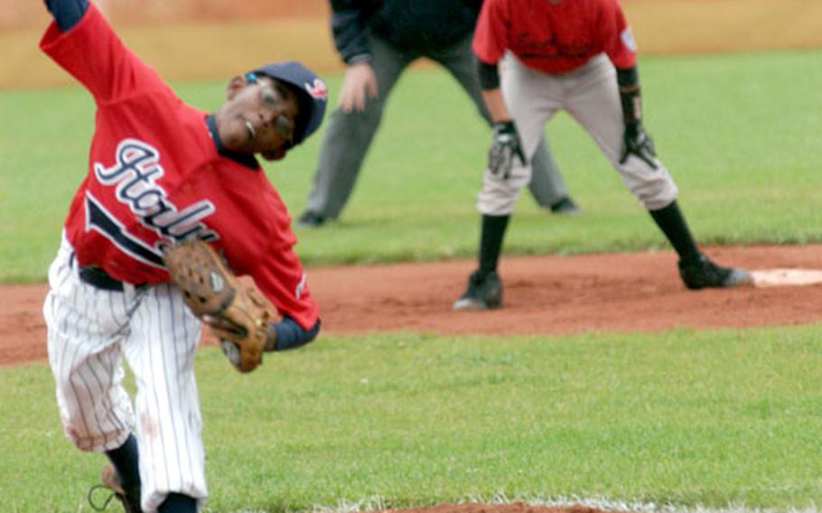 Devon Mitchell of the Naples delivers a pitch as Dustin Bratcher of East Anglia, England, looks on from second base in front of umpire Fred Tempels during Naples&#39; 16-8 victory on Monday.