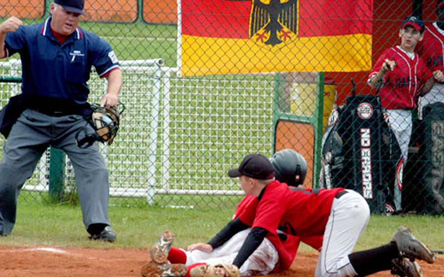 Brussels catcher Henry Lang tags out Ramstein player Tyler Jarvis at home plate during Wednesday's semi-final match in the Trans-Atlantic Region Little League tournament. It was Lang's 12th birthday.