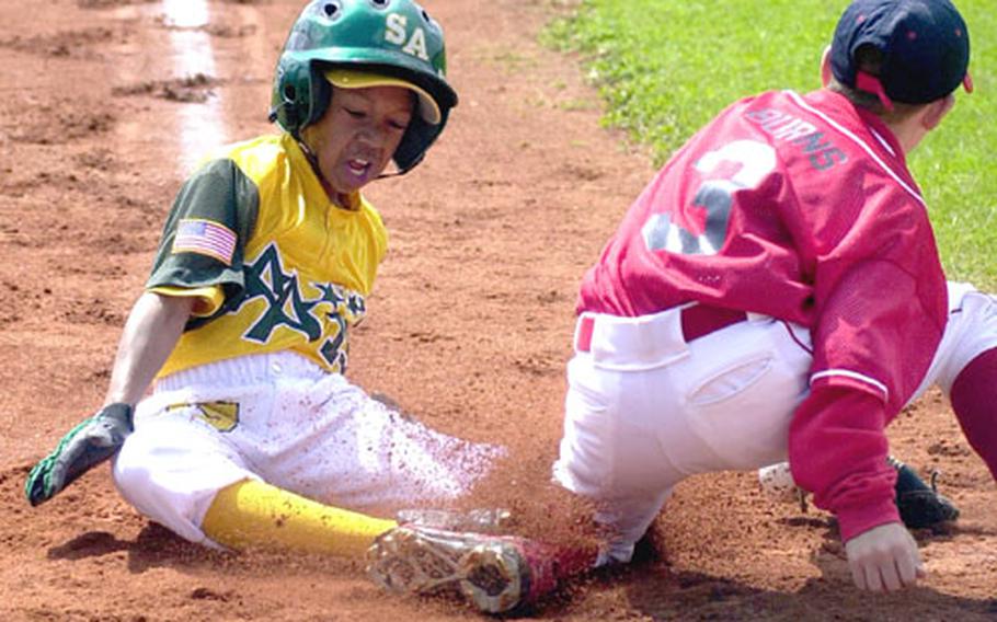 Ramstein pitcher Stephen Burns can&#39;t scoop up a throw in the dirt to put the tag on Saudi Arabia&#39;s Deron Horton in first-inning action at the Little Leage Trans-Atlantic final in Vilseck, Germany on Thursday. Saudi Arabia won the game 13-2, and will head to Williamsport, Pa., to play in the Little League World Series.