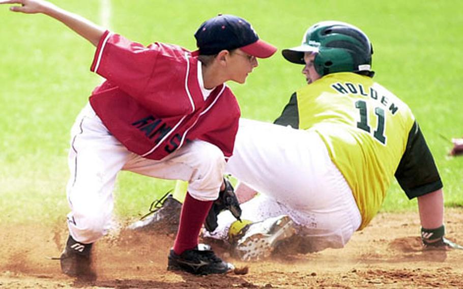 The ball eludes Ramstein third baseman Michael Fisher as Saudi Arabia’s Andrew Holden slides into the bag during the Little League Trans-Atlantic Regional final.