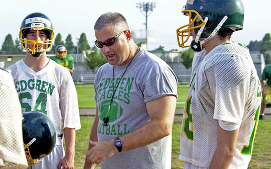 Robert D. Edgren football coach Jim Burgeson, center, is confident that his team, which has gone 9-28 since 2000, will be able to turn it around.