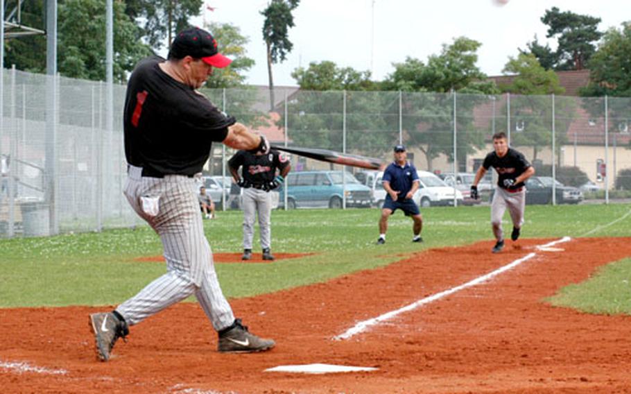 Kaiserslautern Panthers pitcher Andrew Fabrizio, left, sends one toward the outfield as a baserunner eyes home plate in the seventh inning of Sunday’s men’s championship finals in Grafenwöhr.