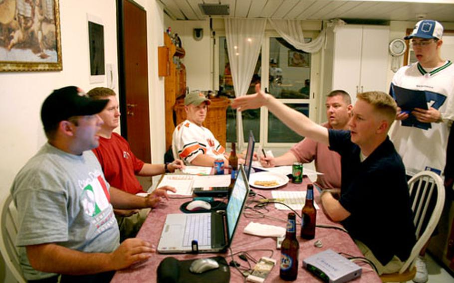 Sailors get into a heated but friendly argument over the merits of an NFL player compared to another when they gathered this month at the house of Petty Officer 1st Class Dre Armeda, seated far left, to draft their fantasy football teams. Next to Armeda, seated clockwise, are Chief Petty Officer Ken Bruner, Petty Officer 2nd Class Austin Brown, Petty Officer 2nd Class David Jensen and Petty Officer 2nd Class Troy Todd.