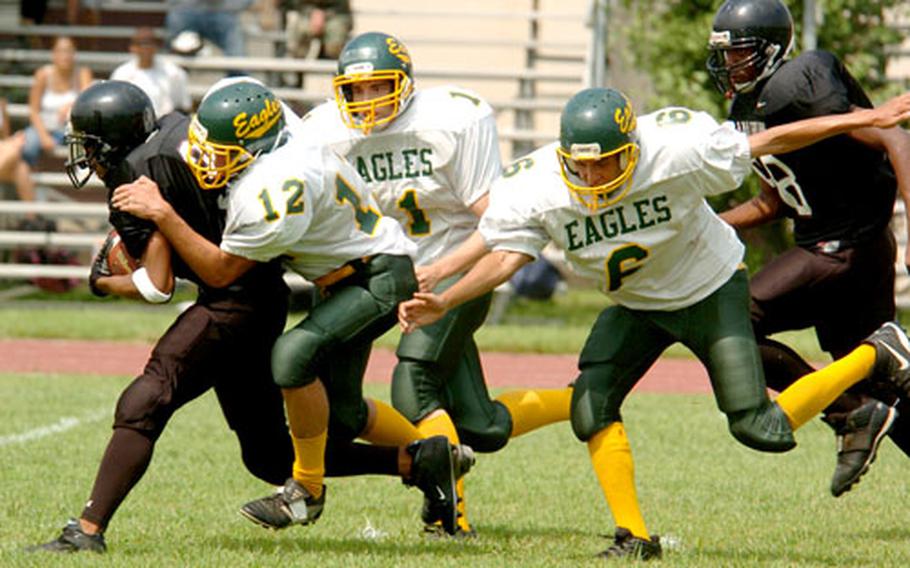 A Zama Trojan is tackled by Edgren players.