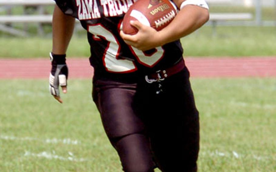 Zama’s Christian Sandiko runs the ball on Saturday.