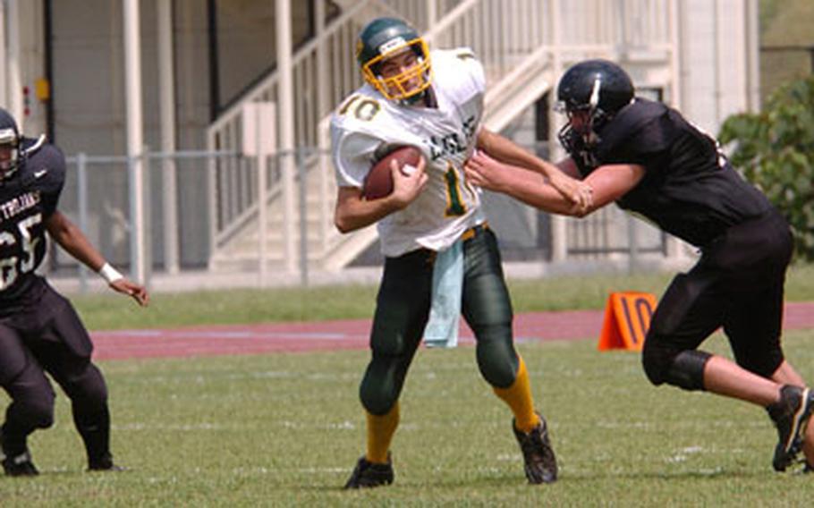 Edgren quarterback Josh Ray evades two Zama defenders.