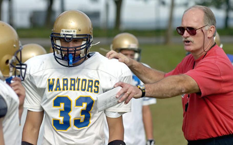 Wiesbaden assistant coach John Ewald directs Chase Socha and the defense during practice Tuesday in Wiesbaden, Germany.