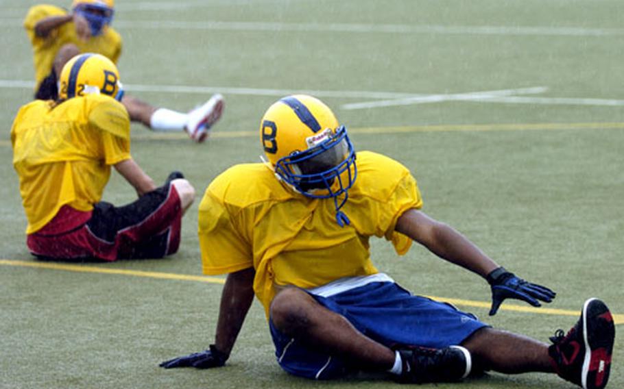 Bamberg high school football players do calisthenics in the pouring rain during practice in Bamberg, Germany, on Monday. The Bamberg team has been hit especially hard by deployments and had only 18 players for their squad as of Monday.