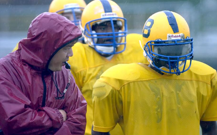 Bamberg head coach Jim Davis talks with T&#39;Andre Stuckey during special teams practice in Bamberg, Germany, on Monday. Behind Stuckey are Brian Thames and Riley Livingston.