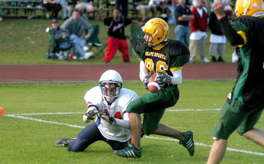 SHAPE’s Zack Rabiego intercepts a pass in the closing seconds to end the final hopes of the Lakenheath Lancers on Saturday. The pass was intended for Justin Fisher, on the ground. SHAPE won the season opener for both teams, 14-7.