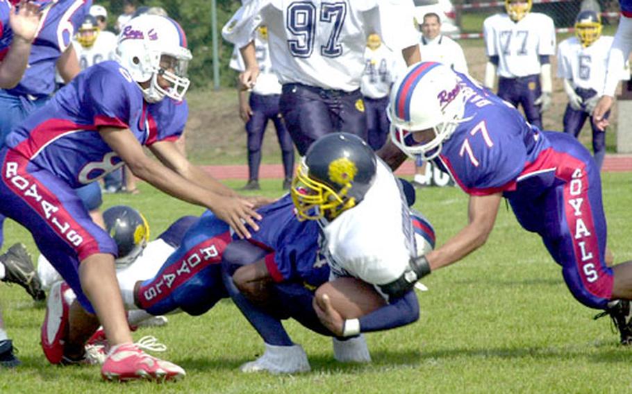 Ramstein defenders bring down Heidelberg running back Lewis Allen Jr. during Saturday&#39;s game.