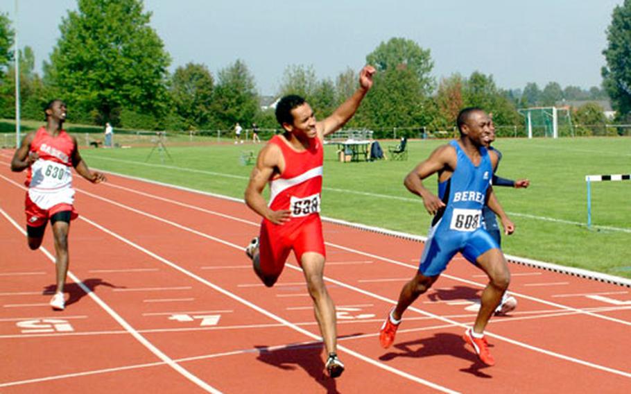 Ramstein’s Oscar Gramling, right, edges Hanau’s Jamie Eckford in the 100 meters Saturday at the U.S. Forces Europe track championships in Hanau, Germany.