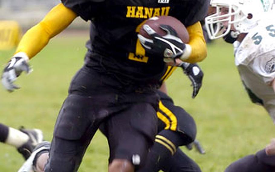 Hanau’s Malcolm Lane, left, beats Naples’ Nate Jankowski to the outside for a big gain during a DODDS high school football game in Hanau, Germany, on Saturday. Hanau shut out Naples 21-0.