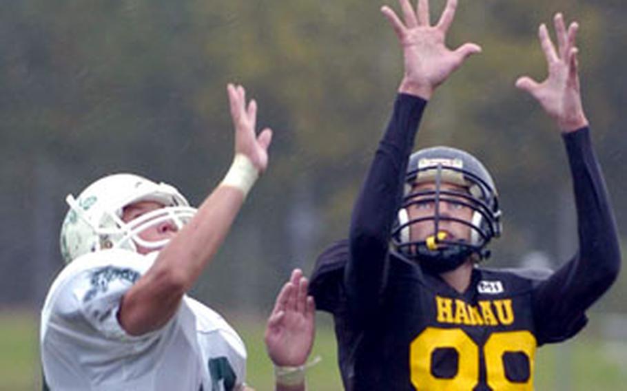 Hanau’s T.J. Shulson, right, hauls in a pass over Naples’ Will Carrico on Saturday.