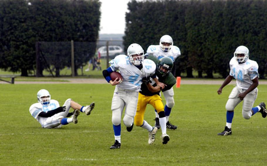 Alconbury’s Andrew Hunt tries to pull down Brussels’ Kevin LaBelle in the first half.