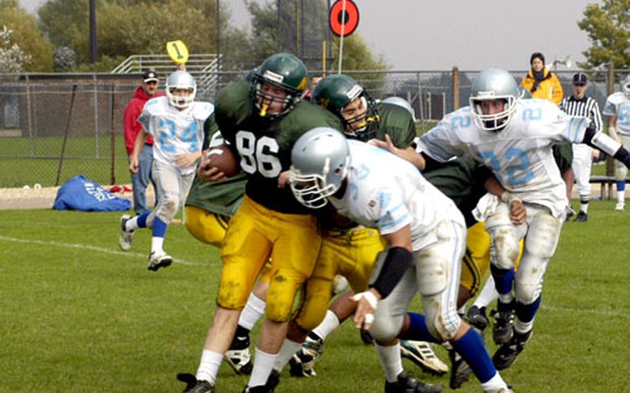 Alconbury Dragons’ Alex Davis is gang-tackled by Brussels defenders.
