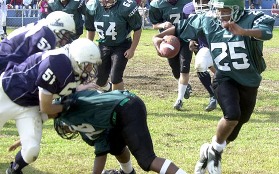 Quarterback Daniel Pressley, right, of Taegu American follows a block on the first drive of Saturday’s DODDS-Korea game against Seoul American at Yongsan Garrison, South Korea. Seoul American won 20-6.