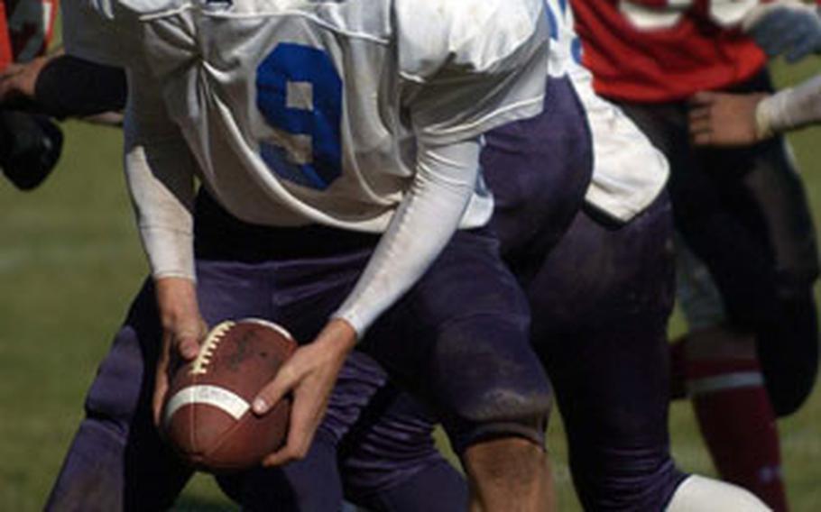 Sigonella quarterback Adam Presnell looks to pitch the ball late in the fourth quarter Saturday against Giessen.